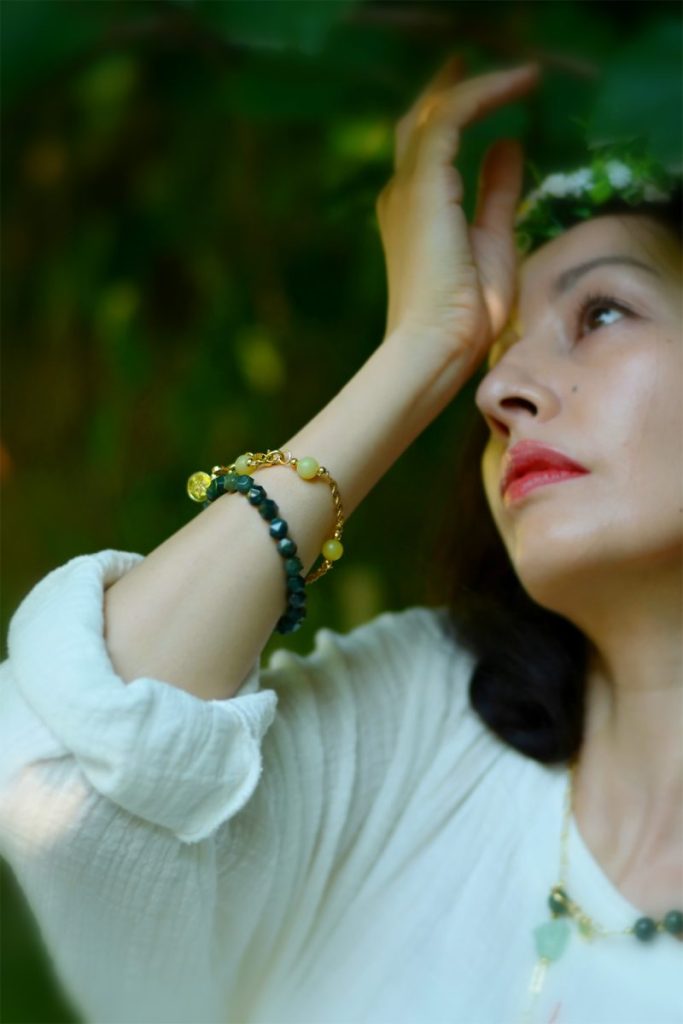 Model wearing Green Fluorite and Yellow Jade bracelets and necklace, representing Heart Chakra growth and Solar Plexus
