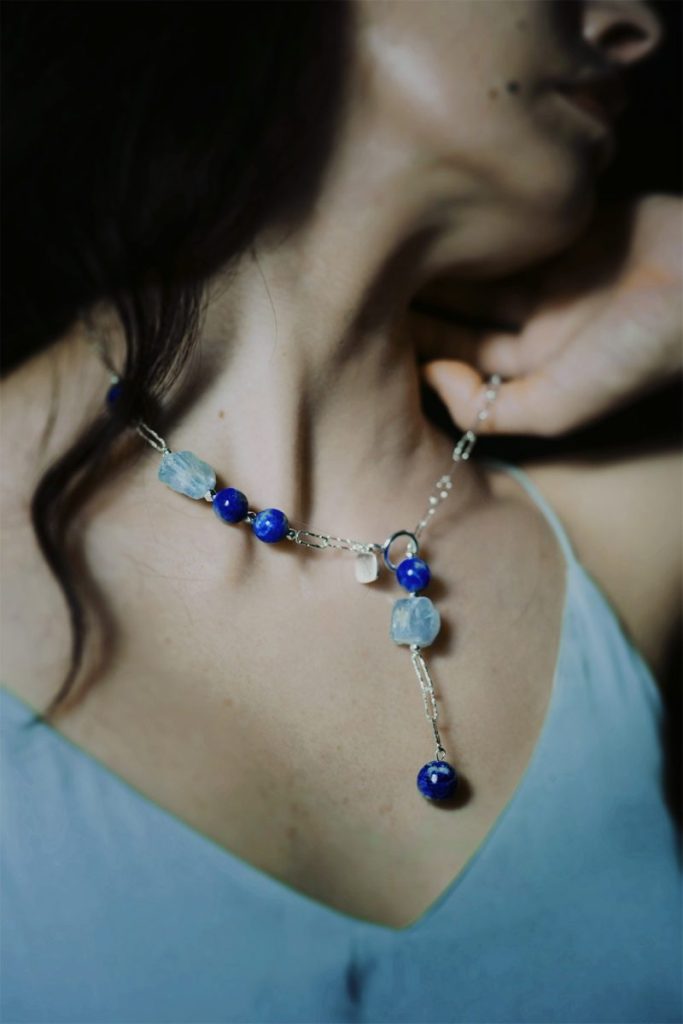 Lariat-style necklace featuring raw Lapis Lazuli and Aquamarine gemstones for Throat Chakra communication and truth.