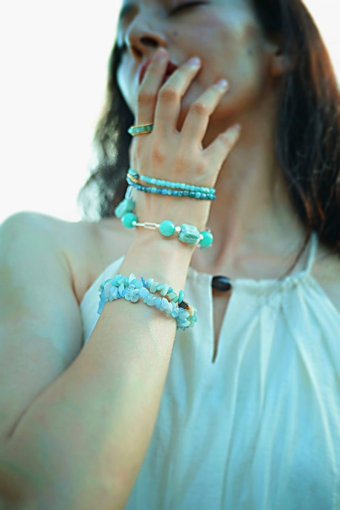Stacked Amazonite and Aquamarine beaded bracelets worn on the wrist for calming energy and emotional balance.